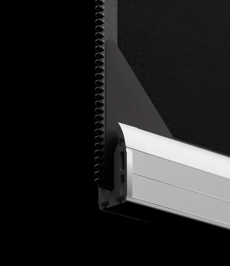 Black and white close-up of the screen bottom bar corner, showing the zipper edge meeting the white aluminium bottom rail